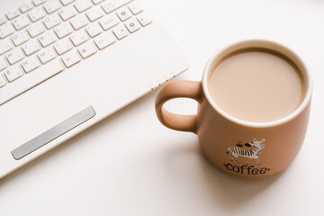 office desk, laptop with coffee mug, coffee mug on white background 