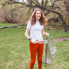 People collect garbage and plastic bottles in the forest