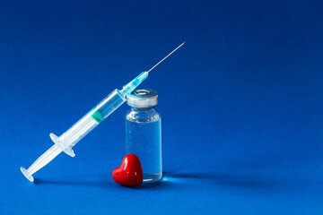 The vaccination fluid bottle with a syringe and a little red heart