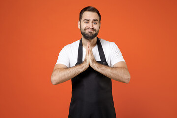 Young man barista bartender barman employee in black apron white t-shirt work in coffee shop hands...