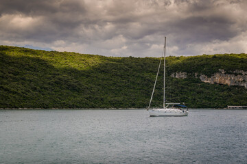 Obraz premium little boat sailing on a river