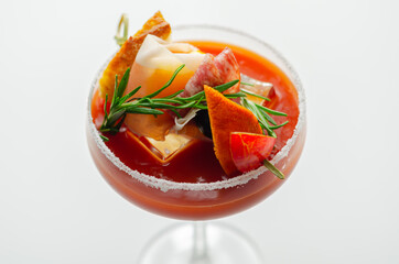 Bloody Mary with interesting decoration with a small snack on top of a cocktail glass