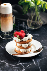 Gingerbread cake on a plate next to a cup of coffee