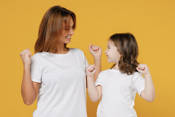Happy woman in basic white t-shirt have fun win with cute child baby girl 5-6 years old. Mommy...