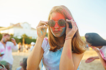 A group of friends have fun,  dance at the holi festival. Spring Break Beach Party. Celebrating...