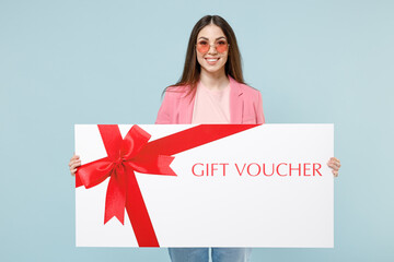 Young fun excited happy overjoyed caucasian woman 20s wearing pastel pink clothes glasses hold...