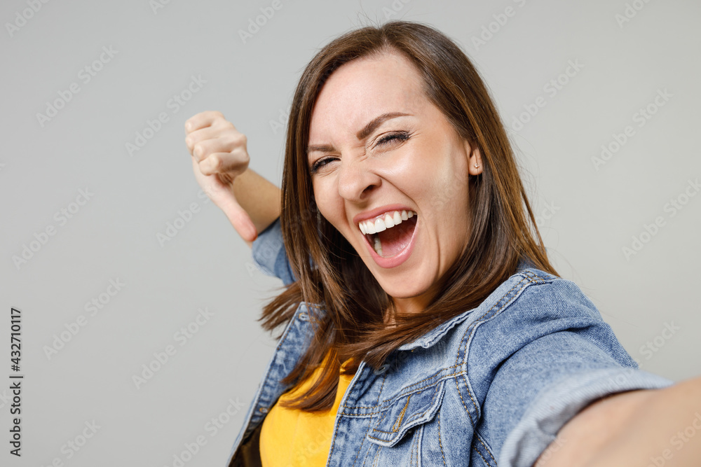 Wall mural close up young fun confident happy caucasian woman 20s wear casual denim jacket yellow t-shirt doing