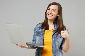 Young fun excited caucasian woman 20s in casual trendy denim jacket yellow t-shirt point index...