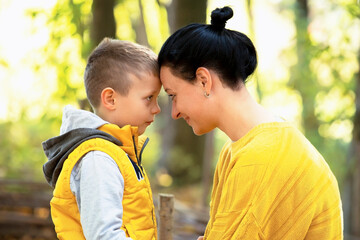 mother and son touch their foreheads