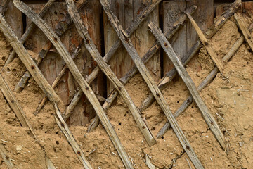 Textured drawing created on the wall of the barn with shingles and crumbling plaster.
