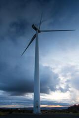 Fototapeta premium Wind Turbine on a windfarm at Sunset.