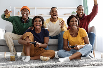 Joyful black fellows having fun at home