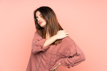 Young caucasian woman isolated on pink background suffering from pain in shoulder for having made an effort