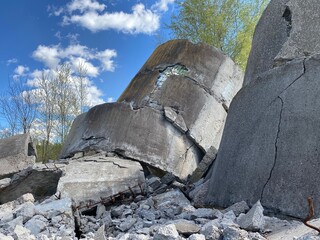 Ruined old concrete building, remnants of civilization, ruins against the sky with clouds, concrete structures against the sky