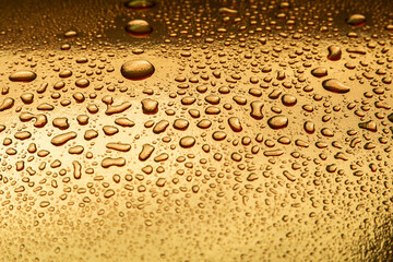 Abstract background with water drops on a gold surface