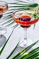 Fresh summer strawberry cocktail or mocktail on the table in garden.Creative drink beverage on sunlight with shadows.