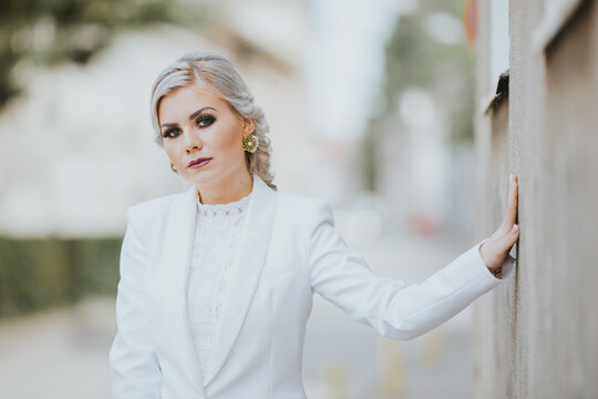 Blonde Female Posing In An Elegant White Pantsuit