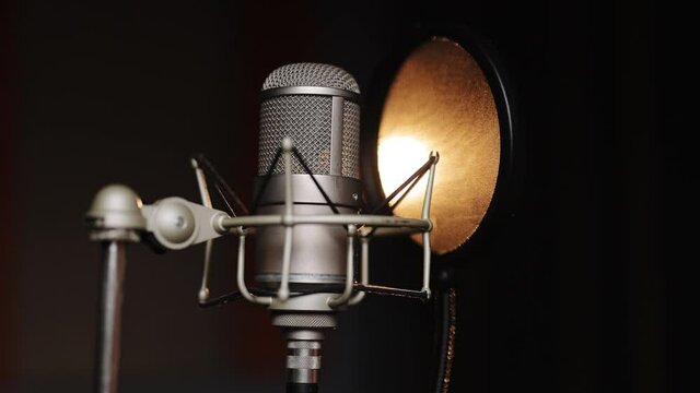 Professional microphone for dubbing and voice over in the sound recording studio. Close up, podcasting concept.