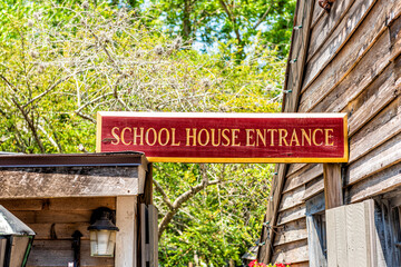 Fototapeta na wymiar St. Augustine, Florida downtown old town city with oldest wood school house in Spanish colonial quarter in summer with red sign text entrance
