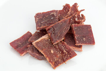 Beef jerky pieces on white background.
