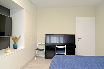 Living room interior with piano and TV