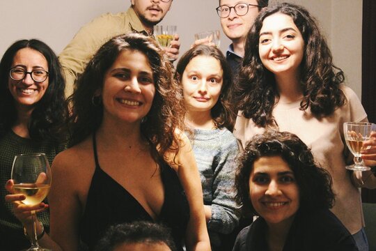 group of friends at a house party looking at camera smiling having fun