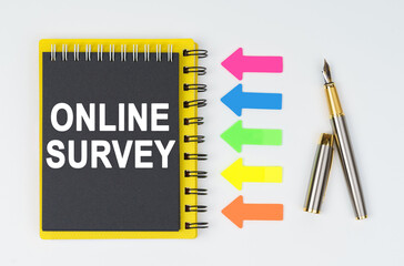 On a white background lies a pen, arrows and a notebook with the inscription - ONLINE SURVEY