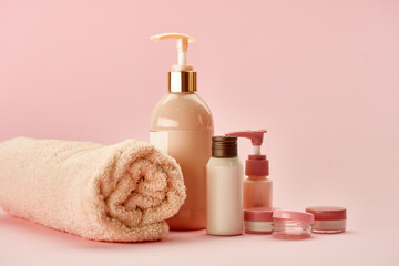Skin care products on pink background, nobody