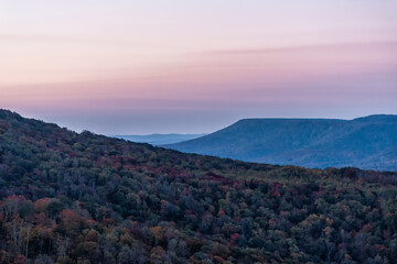 Fototapeta na wymiar High angle view on West Virginia Monongahela national forest Little Laurel mountains overlook in Highland Scenic Highway in autumn with colorful tree foliage at morning sunrise with rolling hills