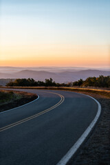 Vertical view on fall autumn season with sunrise at winding Highland Scenic highway 150 road in West Virginia Monongahela National Forest Appalachian mountains