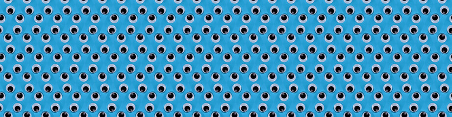 banner seamless pattern of plastic eyes on a blue background
