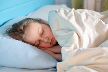 Fototapeta na wymiar Cute child little girl sleeps in the bed