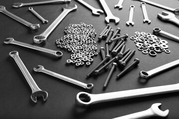 wrenches, iron nuts and bolts on a dark background