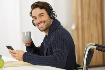 happy man in wheelchair in office