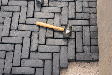 Paving stone driveway installation, 90 degree pattern laid by hand.