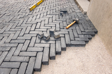 Paving stone driveway installation, 90 degree pattern laid by hand.