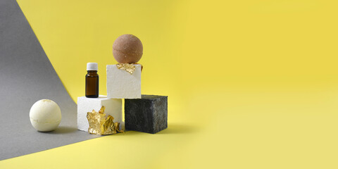 Mock up minimal spa concept with bath bombs, bottle on textured and gold pedestals. Beauty...