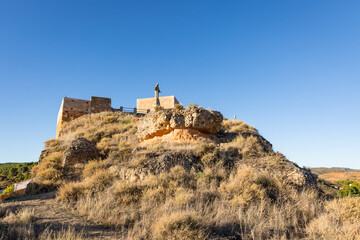 the castle and the monument to the Sacred Heart of Jesus on the hill in Arcos de Jalon, province of Soria, Castile and Leon, Spain 