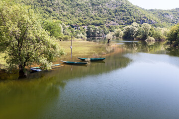 Fototapeta na wymiar Drowned river valleys coast of the Rijeka Crnojevica town. It is near the coast of Skadar lake. The Balkan Peninsula, Montenegro