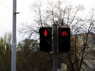 red light is on at traffic lights for pedestrians and cyclists during the day