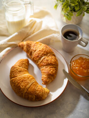 Croissants, coffee, orange jam, breakfast. Nice presentation. Freshly brewed coffee, aromatic croissants, aromatic jam. Delicious and healthy food.