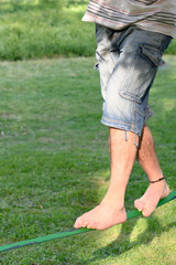 Fototapeta premium Legs of a man on a tightrope.