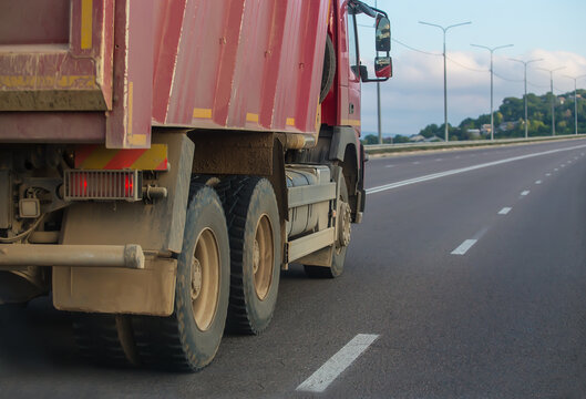 dump truck moves along a country road
