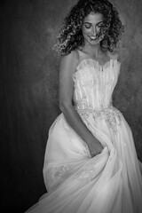 Fototapeta na wymiar A black and white image of a young woman wearing a vintage wedding dress