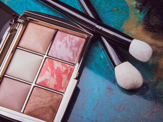 premium cosmetics on craft paper. makeup brushes, mascara and powder