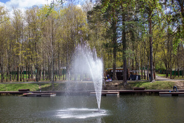 Moscow region Krasnogorsk city 07 05 2021.Park on Ivanovskiye prudy.Fountain in the middle of the pond.