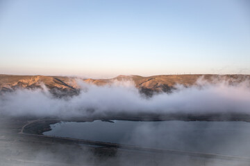 Beautiful clouds flying over the lake near mountains. Evening time shot over the clouds. Baku, Azerbaijan.