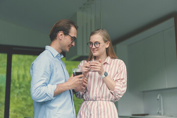 Young couple drinking coffee and discussing family business on the kitchen