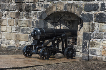 Fototapeta na wymiar Black cannon on the castle hill.