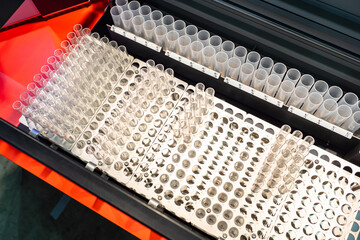 Metal racks for test tubes, top view. Lab equipment. Racks for laboratory glassware. Laboratory glass production concept. Manufacturing of medical test tubes. Laboratory glassware sale.